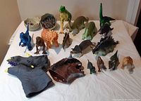Group shot of all dinosaur figures, hand puppets and puzzle pieces