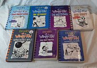 Seven Diary of a Wimpy Kid hardcovers laid out front covers visible