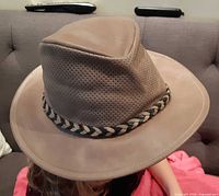 Side view of tan outback hat on head showing ventilated crown and braided band