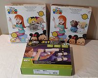 Front view of two Disney Tsum Tsum sew kits and one EduScience telescope kit