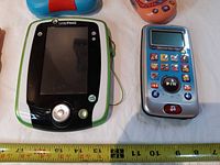 LeapPad2 tablet and VTech music player with tape measure for scale