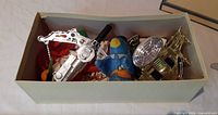 box with chrome gun, gold part, plush toy