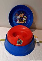 Potty chair assembled with lid open showing graphics