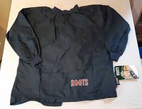 Front view showing navy windbreaker, pocket embroidery and hang tag