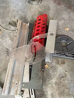 Overview of fence rail, red featherboard, acrylic guard, round insert ring and mounting plates