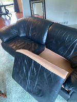 Front angled view showing sofa, missing seat cushion, general style