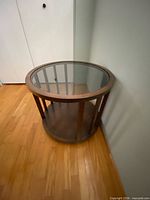 oblique view showing glass top, wood frame and lower shelf
