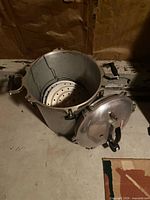 Open pressure cooker-canner body showing interior and racks, lid resting at side