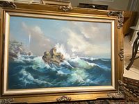 Framed seascape oil painting showing entire artwork and frame