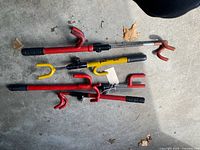 Four steering wheel locks laid out on floor