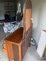 Side and back view of dresser showing wood veneer construction and mirror support
