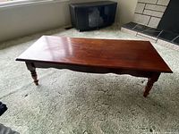 Top view of rectangular cherry wood coffee table showing overall surface and finish