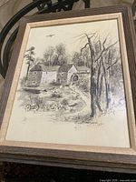 Full view of framed ink drawing showing subject, frame and mat
