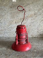 Front view showing overall form, flared base, vented cap, looped handle