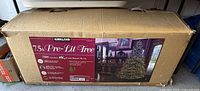 Box showing Kirkland Signature 7.5 ft Pre-Lit Tree labeling
