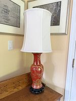 Full view of lamp with shade on wood table