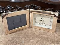 Full view of hinged clock open showing photo frame and dial