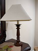 Full view of lamp with shade on furniture surface