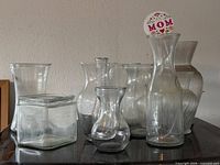 Group of seven clear glass vases in various shapes