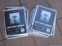 Stack of packaged lace café curtains