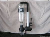Full view of dispenser mounted with inverted bottle showing measuring chamber