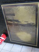 Full view of framed brass etching with soda can for scale