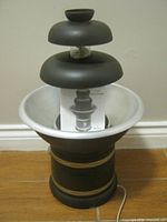 Front view of Rival chocolate fountain showing tiers, bowl, base and manual
