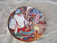 Front view of the decorative plate showing full Santa workshop design
