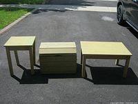 Coffee table, side table and storage box grouped together on driveway