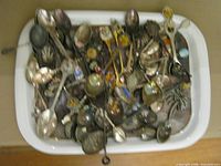 Tray filled with assorted decorative spoons