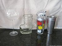 All four items: recipe cocktail shaker with chrome lid, stainless steel shaker cup, boot mug, balloon wine glass