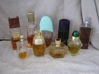 Group shot of nine assorted perfume bottles showing shapes, caps and fill levels