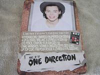 Front of makeup tin showing Harry Styles image and product list
