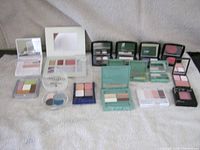 Overview of all makeup compacts on towel