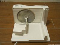 Front view of Rival fold-up meat slicer showing blade and carriage