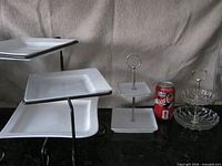 All three serving stands side by side with a soda can for scale