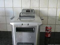 Front and side view of DeLonghi deep fryer with Coca-Cola can for scale