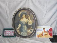 All three advertising pieces grouped: Pepsi oval tray center, Coca-Cola green tray left, Coca-Cola plaque right