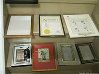 Seven assorted frames on shelf, various materials and sizes
