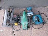 Top view of four corded power tools: circular saw, planer, jig saw, sander