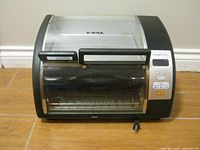 Front view of T-fal toaster oven showing door, control panel, rack, power cord