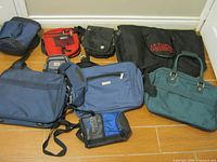 All eight assorted travel bags displayed on floor
