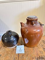 Both stoneware vessels side by side