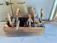 Toolbox filled with assorted vintage tools