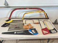 All nine saws laid on table for overview