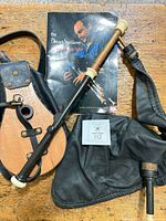 Group shot of bellows, book, bag, pipe section and mouthpiece