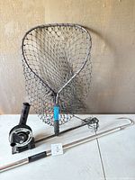 Overall lot showing landing net, downrigger and hook