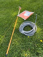 Entire lot showing pole pruner, sealed tarp, coiled hose