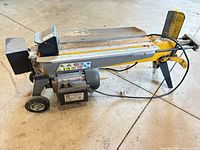 Side view showing complete log splitter with wheels, handle and motor