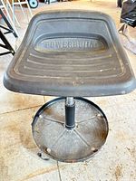 Full view of Powerbuilt stool showing seat, column, tray and casters